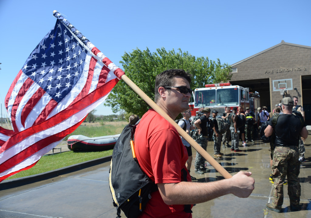 Benjamin Evers, Air Force Personnel Center Outdoor Recreation operations specialist, hold the United States flag July 12, 2014, at Mountain Home Air Force Base, Idaho. Evers held the flag for participants while they performed challenges and obstacles during the GORUCK Light/Team Cohesion Challenge. (U.S. Air Force photo by Senior Airman Benjamin Sutton/Released)